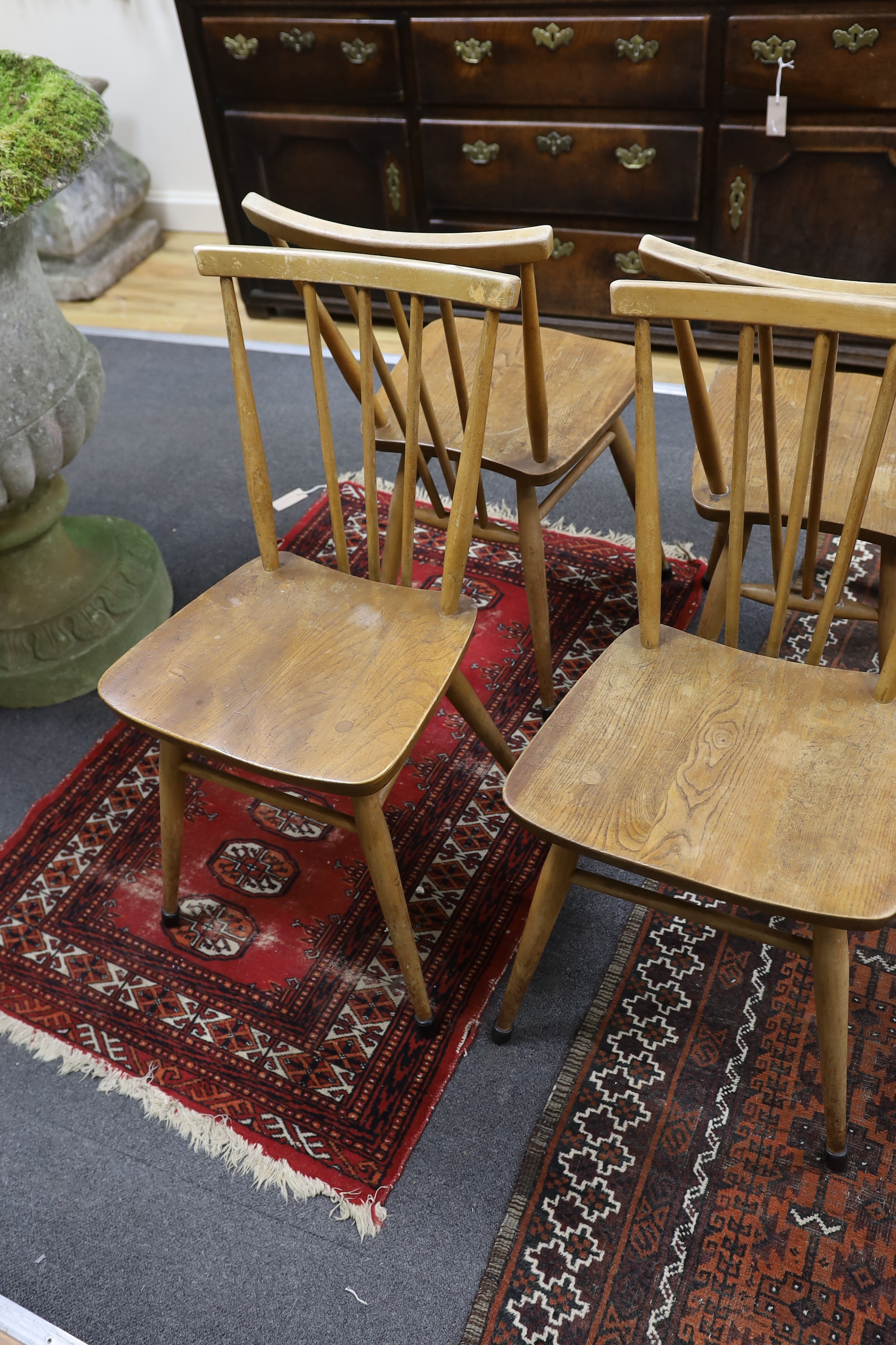 A set of four Ercol elm and beech fan back dining chairs